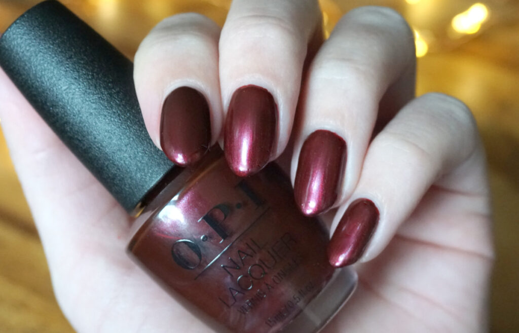 Swatch of OPI Dressed to the wines from the Shine bright holiday 2020 collection. This is a red metallic nail polish.
